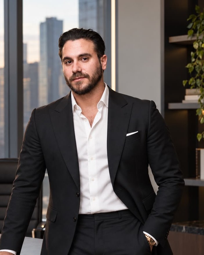 David Oiaknin in an office overlooking a city skyline